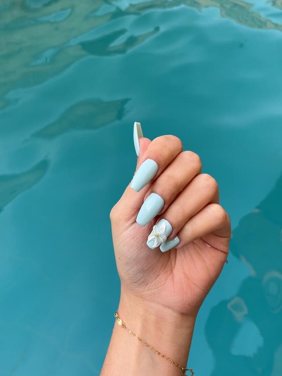 Pastel blue coffin nails with a 3D bow accent